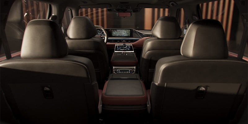 Rear view of the front seats and dashboard in a luxury car.